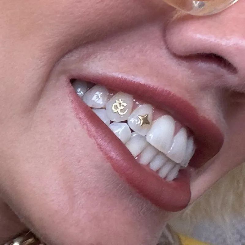 Gold Om symbol and star tooth gems